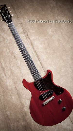 This guitar is red, and it has six strings ... so far.